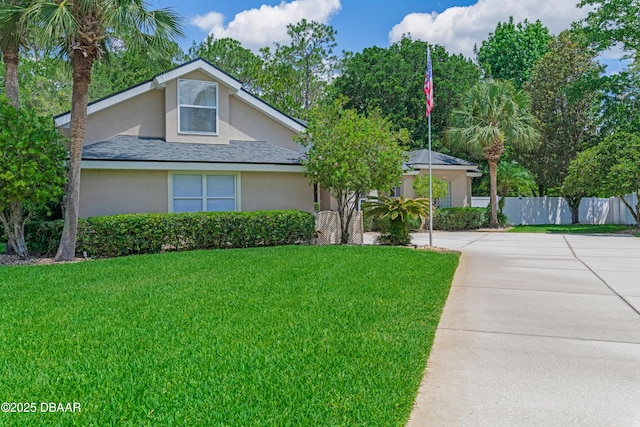 view of front of house featuring stucco siding, driveway, and a shingled roof