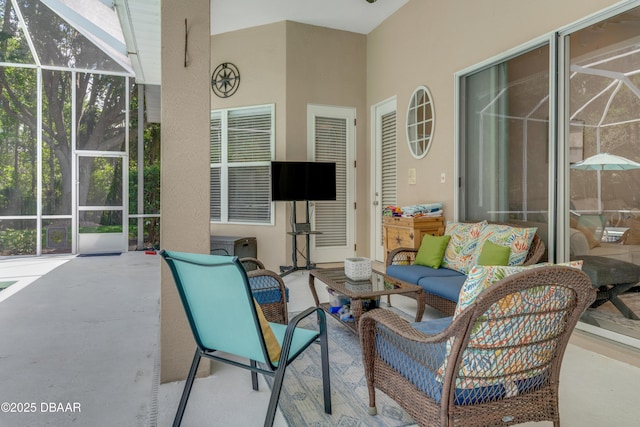 view of patio / terrace featuring glass enclosure