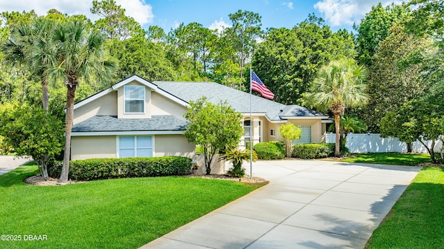 view of front of house featuring stucco siding, roof with shingles, and concrete driveway