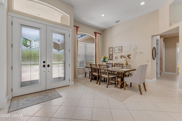 dining room with french doors, light tile patterned floors, baseboards, and recessed lighting