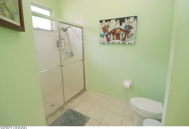 bathroom featuring walk in shower, toilet, and tile patterned flooring