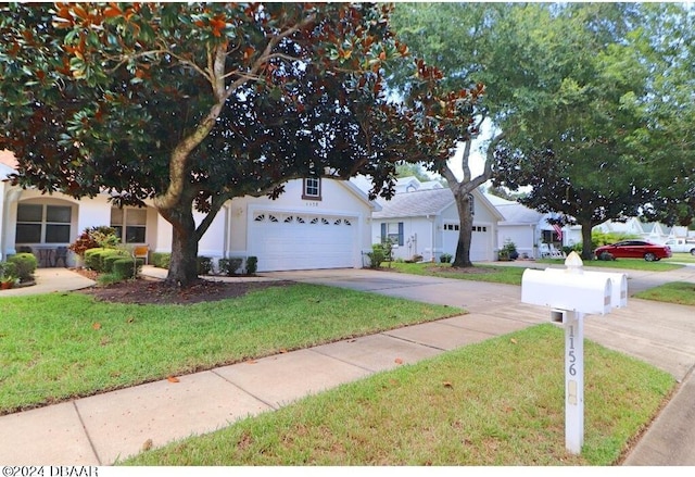 view of front of house with a garage and a front yard