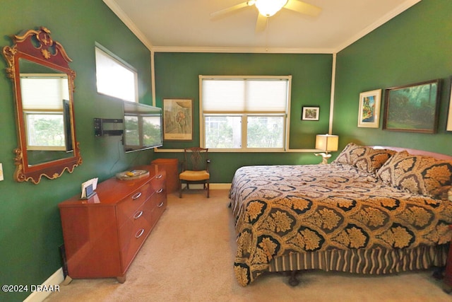 bedroom with ornamental molding, multiple windows, light colored carpet, and ceiling fan