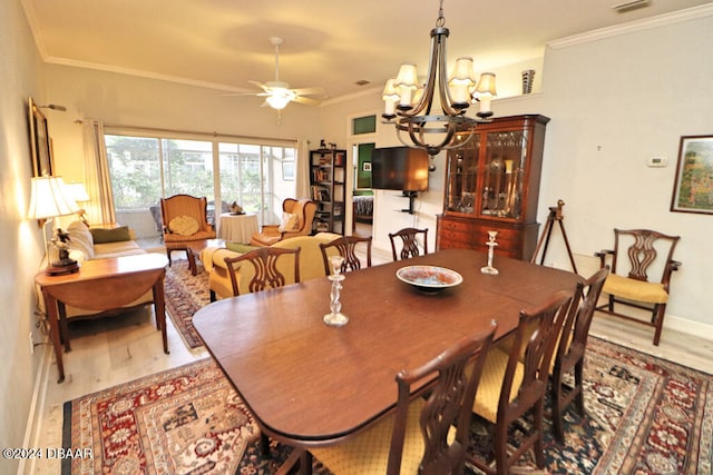 dining room with ceiling fan with notable chandelier, crown molding, and wood-type flooring