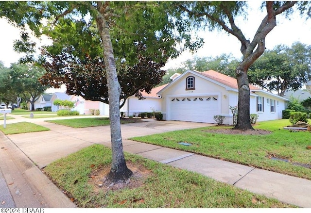 view of front of property featuring a garage and a front yard