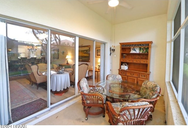 carpeted dining area featuring ceiling fan