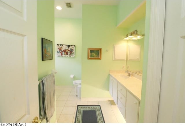 bathroom with vanity, tile patterned floors, and toilet