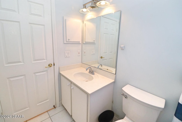 bathroom featuring tile patterned flooring, vanity, and toilet