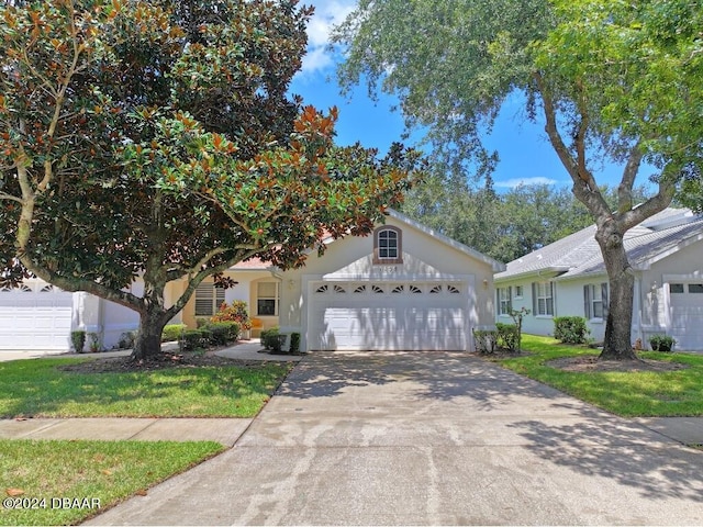 view of front of house with a garage and a front yard