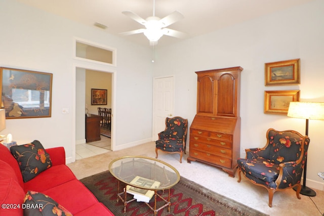 carpeted living room with ceiling fan