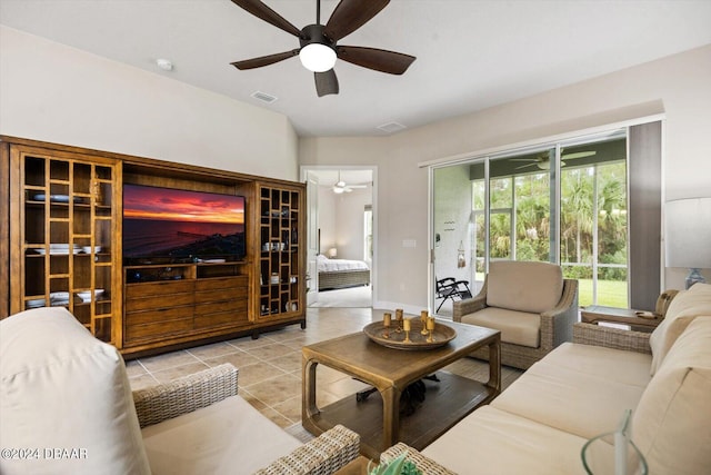 tiled living room featuring ceiling fan