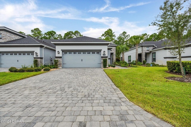 view of front of home with a garage and a front lawn