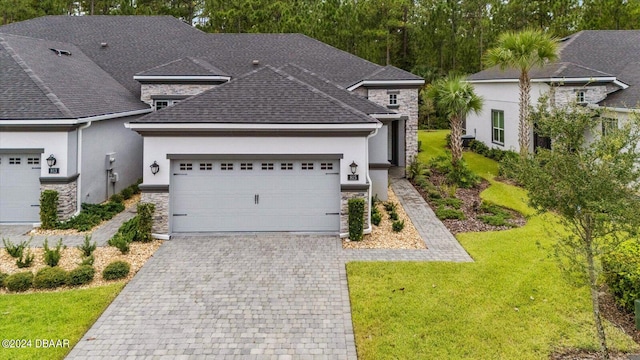 view of front of house featuring a garage and a front lawn