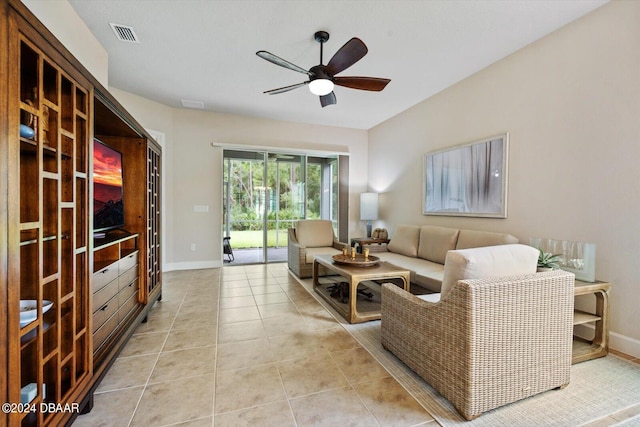 tiled living room featuring ceiling fan