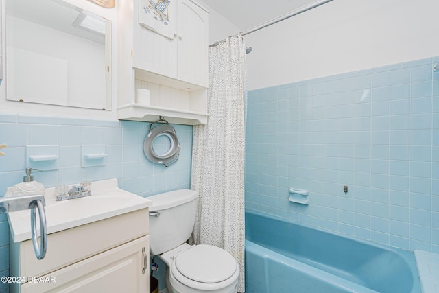 full bathroom featuring vanity, toilet, shower / bath combo, and tile walls