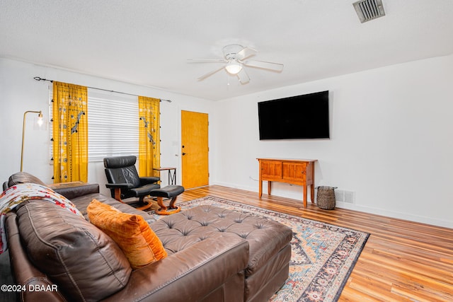 living room with hardwood / wood-style flooring and ceiling fan