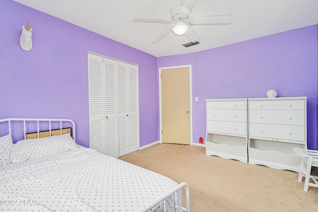 carpeted bedroom featuring ceiling fan and a closet