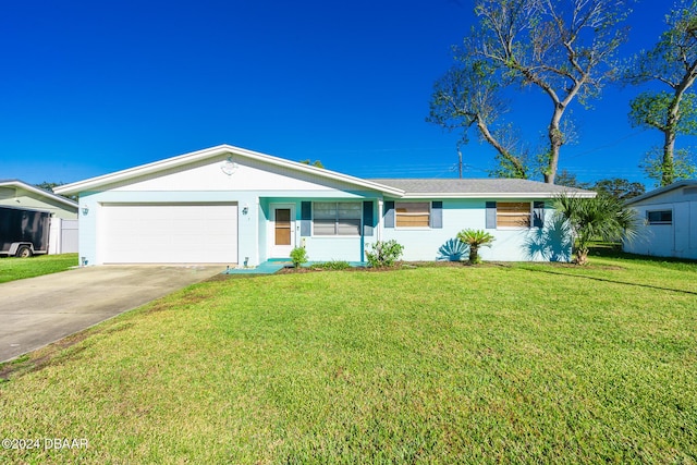 ranch-style home featuring a garage and a front lawn