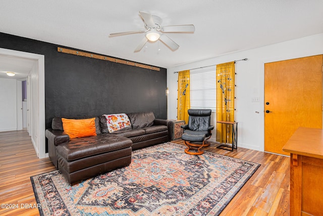 living room featuring ceiling fan and wood-type flooring