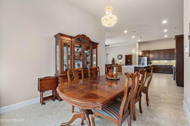 dining area with light tile patterned floors and a notable chandelier