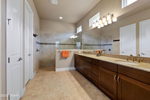 bathroom featuring vanity and a tile shower