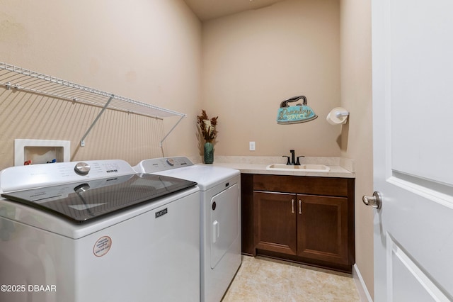 clothes washing area featuring cabinets, independent washer and dryer, and sink