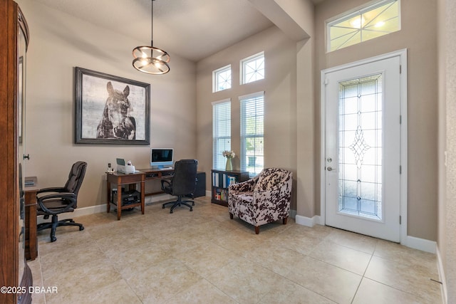 home office with light tile patterned floors and a wealth of natural light