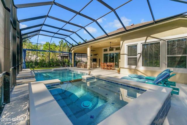 view of swimming pool with a lanai, ceiling fan, a patio, an in ground hot tub, and exterior bar