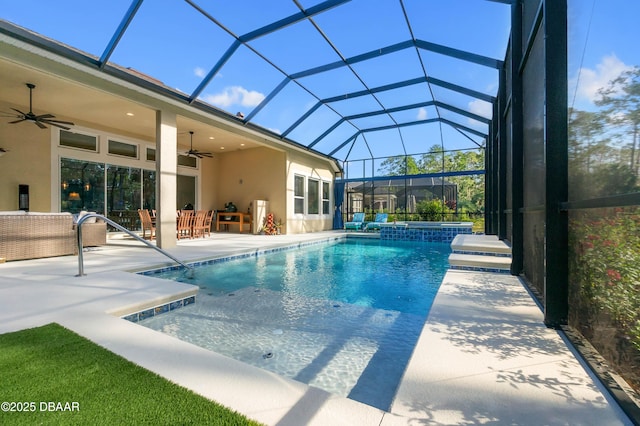 view of swimming pool with outdoor lounge area, a patio, ceiling fan, and glass enclosure