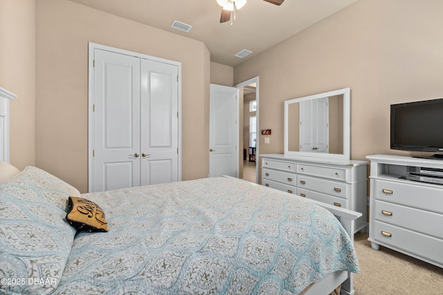 carpeted bedroom with ceiling fan and a closet