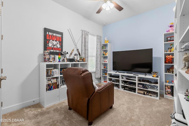 living area with ceiling fan and carpet