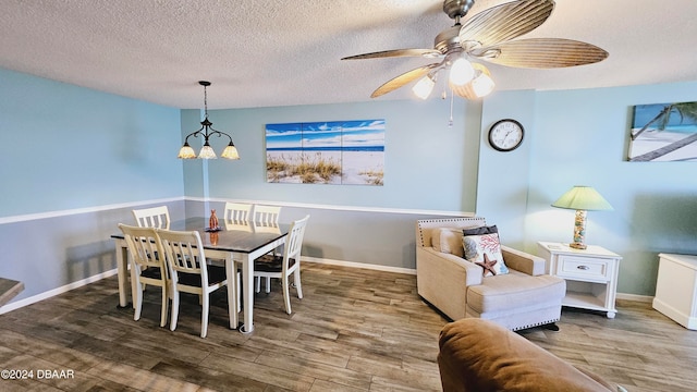 dining area featuring a textured ceiling, hardwood / wood-style flooring, and ceiling fan