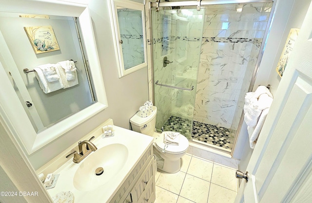 bathroom with vanity, walk in shower, tile patterned flooring, and toilet