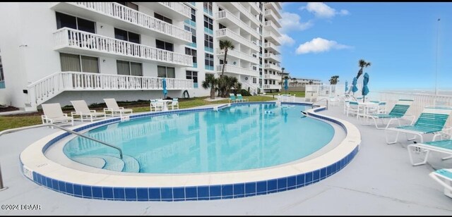 view of swimming pool with a patio