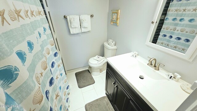 bathroom featuring toilet, vanity, and tile patterned floors