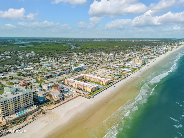 bird's eye view featuring a water view and a beach view