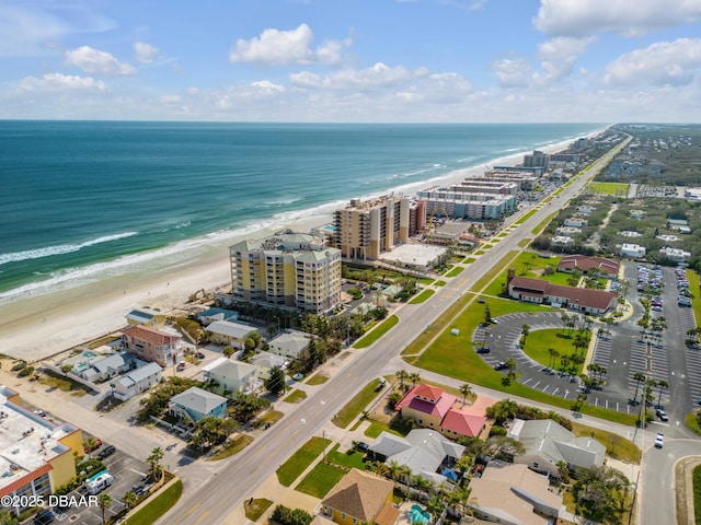 birds eye view of property with a view of the beach and a water view