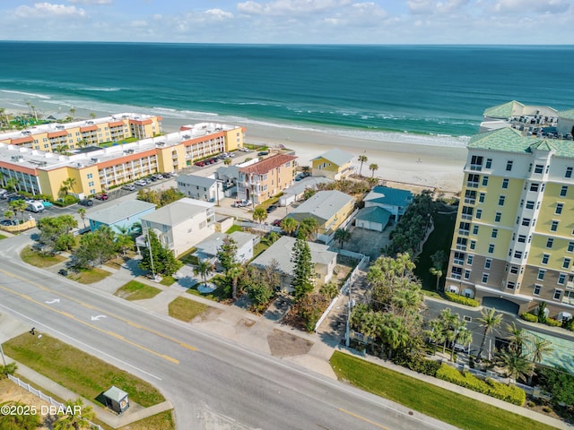 drone / aerial view with a water view and a beach view