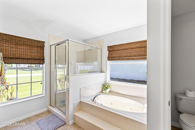 bathroom with a tub with jets, a shower stall, toilet, and tile patterned floors