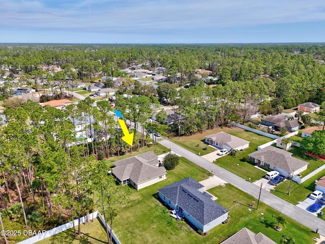 birds eye view of property with a residential view and a view of trees