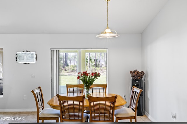 dining room featuring baseboards and light tile patterned flooring