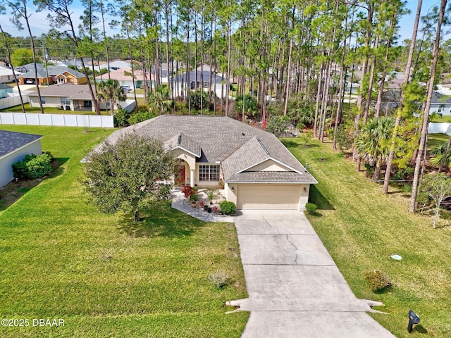 view of front of property featuring driveway, a garage, a shingled roof, a residential view, and a front lawn