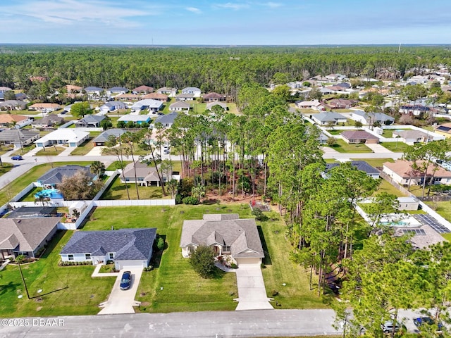 birds eye view of property featuring a wooded view and a residential view