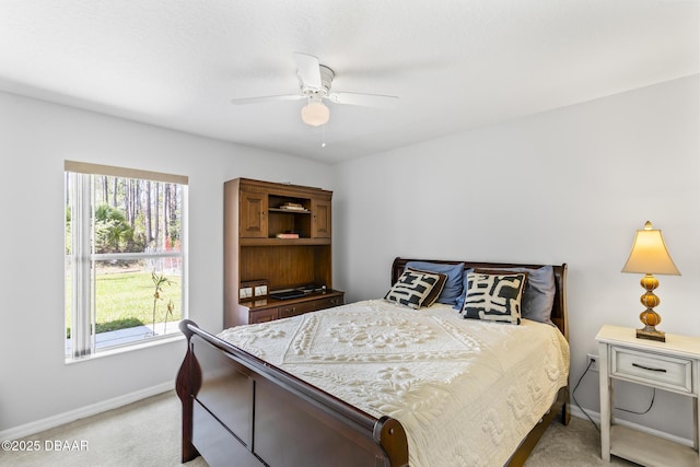 bedroom with light carpet, multiple windows, and baseboards