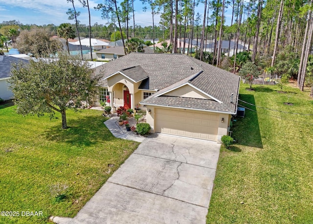 single story home with a garage, a front lawn, roof with shingles, and stucco siding