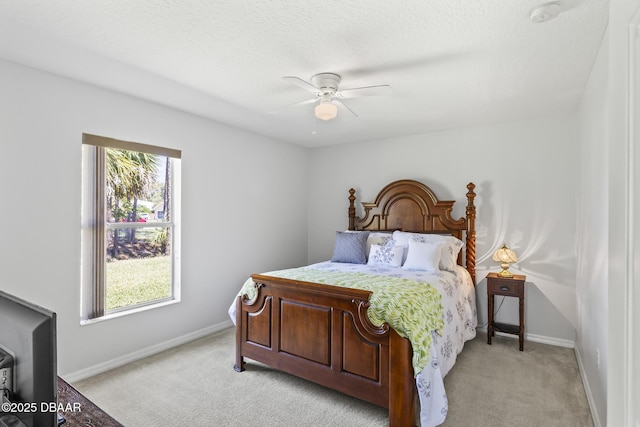 bedroom featuring light carpet, ceiling fan, and baseboards