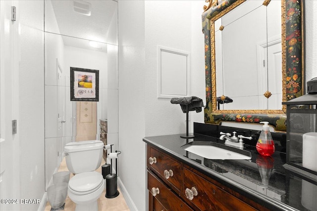 bathroom featuring vanity, tile patterned floors, and toilet