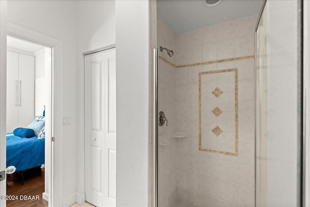 bathroom with walk in shower and hardwood / wood-style flooring