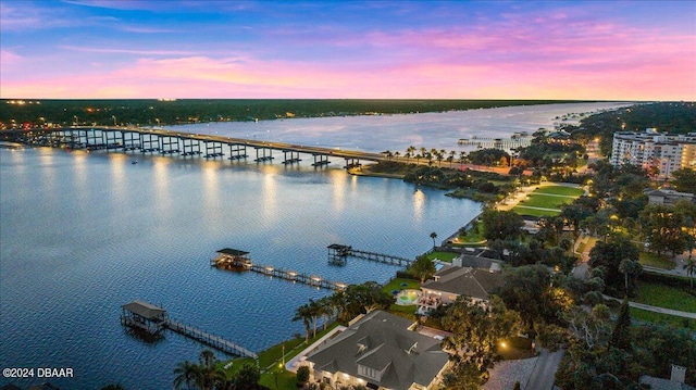 aerial view at dusk with a water view