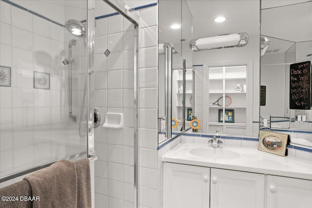 bathroom with an enclosed shower and vanity